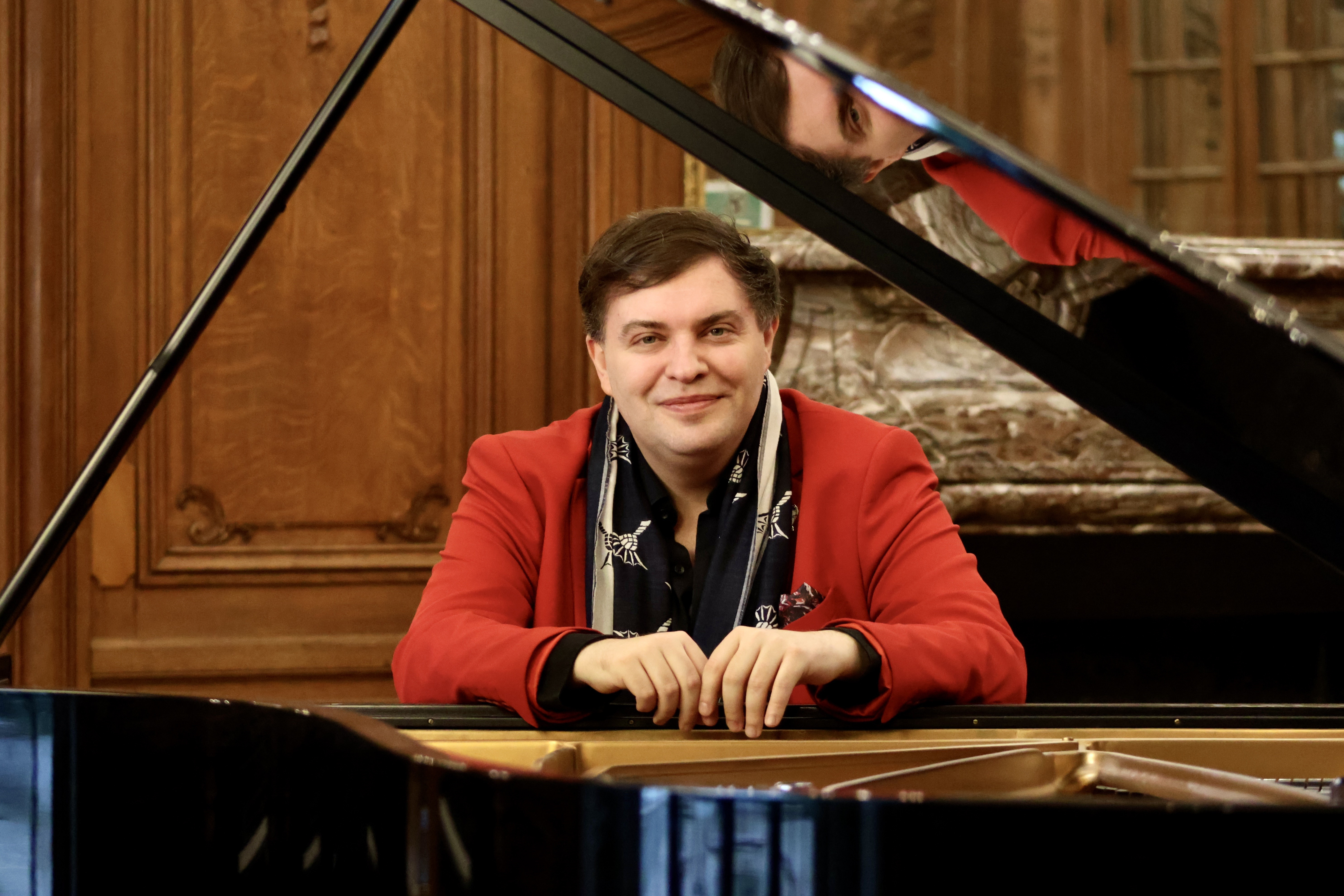 Portrait of a man at an open piano